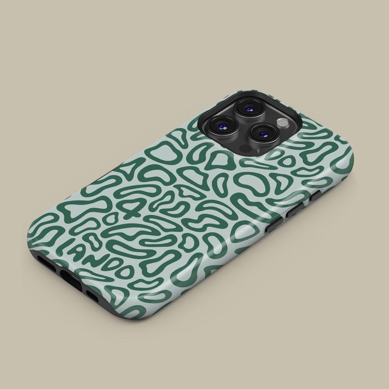 May include: A teal and white phone case with a repeating abstract pattern. The case has a black border and a camera cutout. The word "LANDO" is visible on the case.
