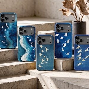 May include: Five rectangular phone cases featuring various blue watercolor-style backgrounds with white bird silhouettes in flight. Each case has a dark gray camera cutout area at the top, showcasing different artistic patterns of ocean waves and sky.