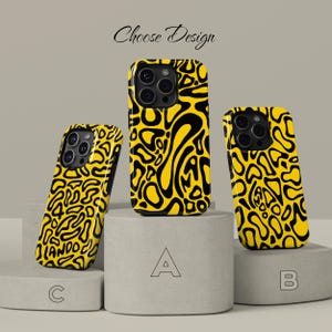 May include: Yellow and black patterned phone cases in three different orientations. The cases are displayed on gray pedestals, with the text "Choose Design" above. Each case has a unique black abstract design on a yellow background.