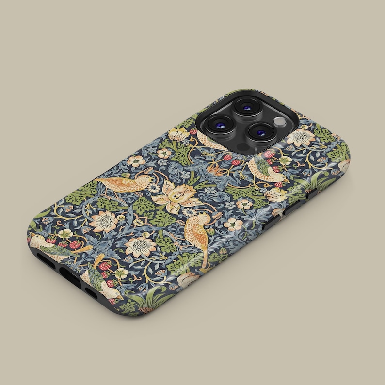 May include: A phone case with a detailed floral and bird pattern. The design features birds, flowers, and foliage in shades of gold, green, and cream against a dark blue background. The case has a black border.