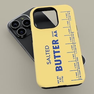 May include: A yellow phone case featuring a stick of butter design. The case has a blue label that reads "SALTED BUTTER AA" and includes a measurement guide in tablespoons and cups. The net weight is 4 oz (113g).