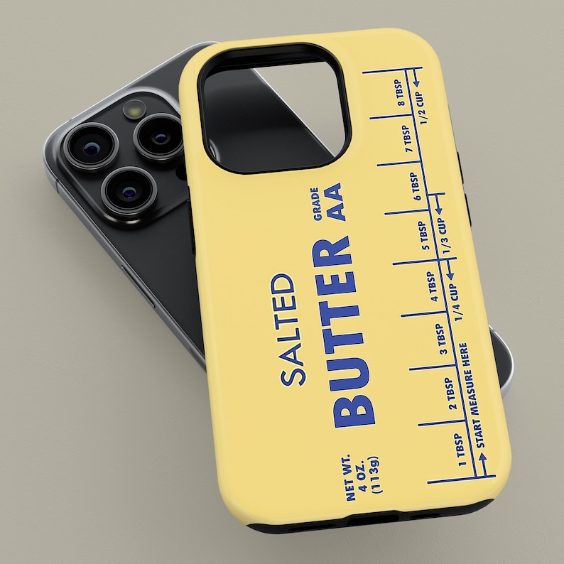 May include: A yellow phone case featuring a stick of butter design. The case has a blue label that reads "SALTED BUTTER AA" and includes a measurement guide in tablespoons and cups. The net weight is 4 oz (113g).