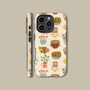Puede incluir: Una funda de teléfono con un patrón repetido de plantas y flores en macetas. El diseño incluye girasoles, margaritas y otras flores en macetas, tazas y regaderas, sobre un fondo crema. La funda se muestra desde el frente y el lateral.