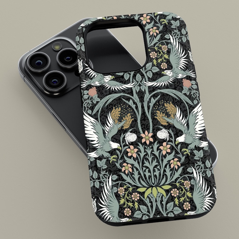 May include: A black phone case featuring a detailed floral and bird pattern. The design includes stylized birds with outstretched wings, flowers, and foliage in shades of gray, green, and peach. The case is shown on a black smartphone.