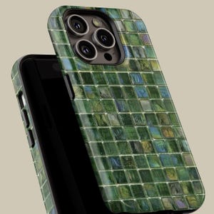 May include: A green and blue mosaic patterned phone case for an iPhone. The case has a raised camera bump and a cutout for the phone's buttons.