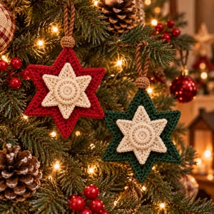 May include: Two six-pointed star ornaments made of crocheted yarn. One star is deep red and the other is dark green, both featuring a smaller, cream-colored crocheted star layered on top. Each ornament hangs from a brown braided cord loop.