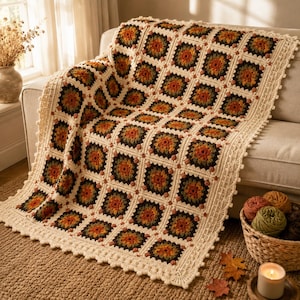 May include: A handmade crochet blanket featuring a repeating granny square pattern in shades of cream, dark green, orange, and brown. The blanket has a decorative scalloped border and is constructed from individual squares joined together.