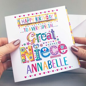 May include: A colorful birthday card with the text "Happy Birthday to a very special Great Niece Annabelle." The card features a vibrant design with floral and heart motifs in various colors, held by hands.