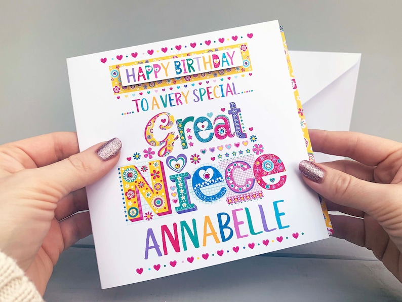 May include: A colorful birthday card with the text "Happy Birthday to a very special Great Niece Annabelle." The card features a vibrant design with floral and heart motifs in various colors, held by hands.