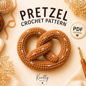 Könnte beinhalten: Ein braunes gehäkeltes Brezel mit weißen Nähten, die Worte "Pretzel Crochet Pattern" sind über der Brezel abgebildet. Das Bild enthält auch Garn, einen Häkelhaken und den Text "PDF Pattern".