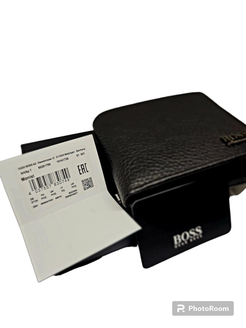 May include: A dark brown leather wallet with a textured surface. The wallet has the brand name "BOSS" embossed on the front. A white tag with the text "Monist" and a barcode is visible.