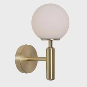 May include: A modern wall sconce featuring a spherical, frosted glass shade atop a brass-colored metal fixture. The fixture has a circular base and a straight arm connecting to the light. The design is minimalist and elegant.