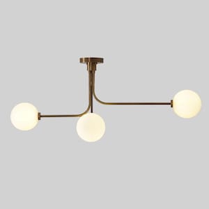 May include: A contemporary ceiling light with three spherical, frosted glass globes. The fixture has a bronze finish and a minimalist design, suitable for modern interiors. The globes are evenly spaced along the horizontal arms.