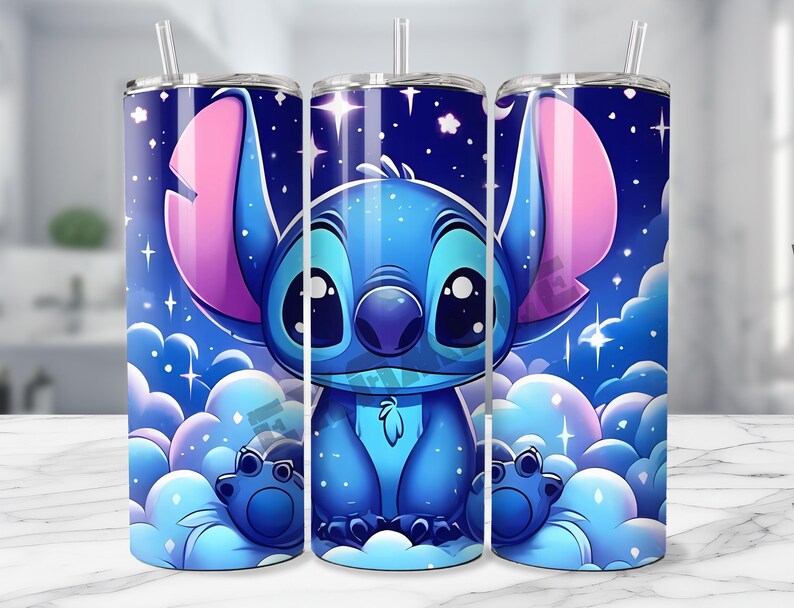 May include: A set of three stainless steel tumblers featuring a cartoon character design. The design showcases a blue alien character with large ears and eyes, set against a starry night sky background with fluffy clouds. Each tumbler includes a straw.