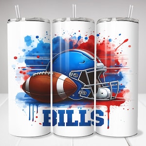 May include: White tumbler featuring a football, blue helmet, and the word "BILLS" in blue. The design includes red and blue watercolor-style splashes. The tumbler has a straw and a black lid.