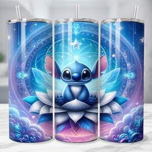 May include: A set of three stainless steel tumblers with a whimsical design. Each tumbler features a blue cartoon character with large eyes, sitting on a white and blue flower, set against a celestial background with stars and clouds. The tumblers have a straw.