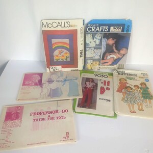 May include: A collection of six vintage sewing pattern envelopes including McCall's 7812 quilt pattern, McCall's Crafts 9051 diaper pattern, Simplicity 9030 pants pattern, Quick Butterick 6089 dress pattern, and two instructional patterns for Professor Bo.