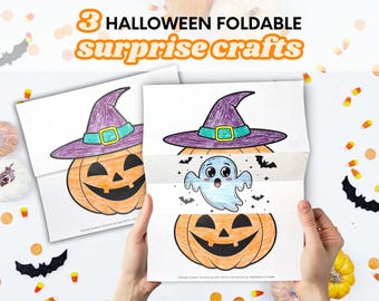 May include: Three Halloween foldable surprise crafts featuring printed paper sheets. One sheet shows a pumpkin wearing a purple witch hat. The other sheet is folded to reveal a hidden blue ghost illustration between two halves of a pumpkin.