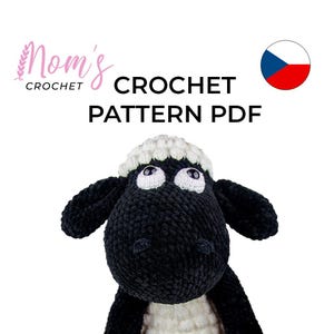 Könnte beinhalten: Häkelanleitung PDF für ein Amigurumi-Schaf in Schwarz und Weiß. Die Anleitung steht zum Download bereit. Das Bild zeigt das fertige Spielzeug.