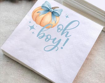May include: A stack of white paper napkins with a light blue pumpkin and bow design. The words "oh boy!" are written in light blue script. The napkins are perfect for a baby shower.