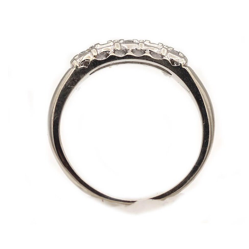 May include: A silver band ring with a row of small diamonds set in the center.