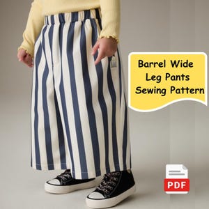 May include: Wide-leg pants with vertical navy blue and white stripes. The pants are part of a sewing pattern, as indicated by the text "Barrel Wide Leg Pants Sewing Pattern" on a yellow background. The image also shows black sneakers with white soles.
