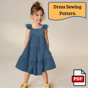Puede incluir: Una niña con un vestido azul escalonado con mangas con volantes y un escote cuadrado. La imagen incluye el texto "Dress Sewing Pattern" en una pancarta amarilla. Un icono PDF está en la esquina inferior derecha.