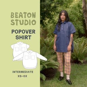 May include: A woman wearing a navy blue popover shirt and plaid pants. The shirt has short sleeves and a button-down collar. The image also shows a pattern for the shirt with the text "BEATON STUDIO POPOVER SHIRT INTERMEDIATE XS-6X."