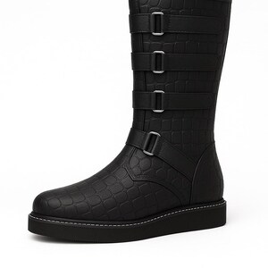 May include: Black mid-calf boot with a textured, crocodile-like pattern. The boot features three straps with silver buckles and a fourth strap at the ankle. The sole is black with white stitching.