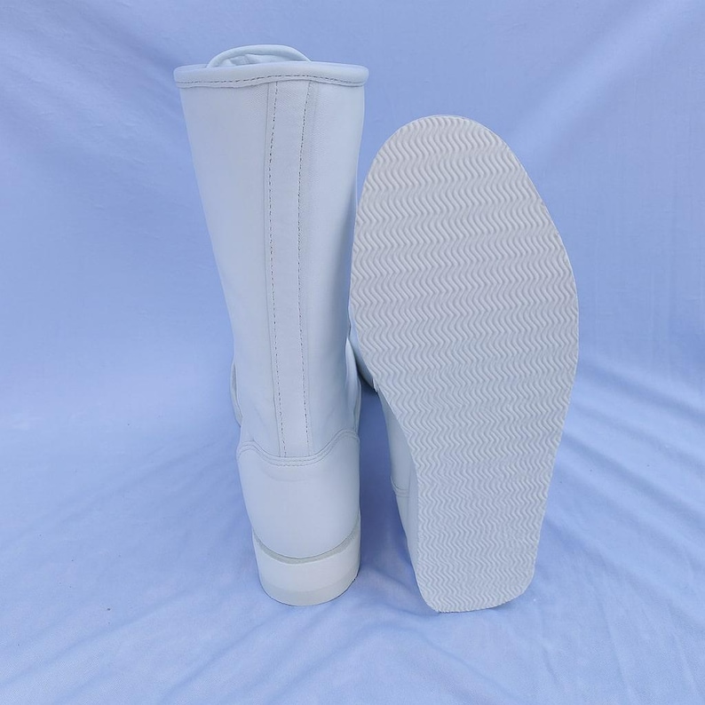 White custom wrestling boots made with authentic genuine leather for professional use. The lace-up design ensures a snug fit and stable support, making them perfect for wrestlers, fighters, stunt performers, and stage artists who require durable and stylish pro wrestling footwear.