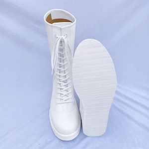 Premium custom white pro wrestling boots featuring genuine leather construction, soft inner padding, and a secure lace-up closure. These high-top wrestling shoes provide strong ankle protection, superior comfort, and long-lasting performance for matches, training sessions, and athletic events.