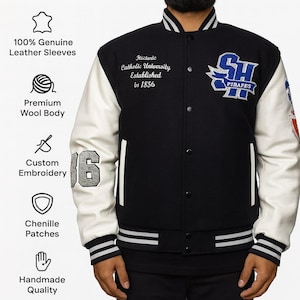 May include: Black varsity jacket with white leather sleeves. Features include custom embroidery, chenille patches, and the text "Historic Catholic University Established in 1856". The jacket has a premium wool body and handmade quality.