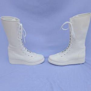 Genuine leather white wrestling boots with full lace-up design, built for pro wrestling performance, training, and competitions. These custom boots offer maximum comfort, stability, and durability, making them an excellent choice for athletes seeking high-quality, long-lasting wrestling shoes.