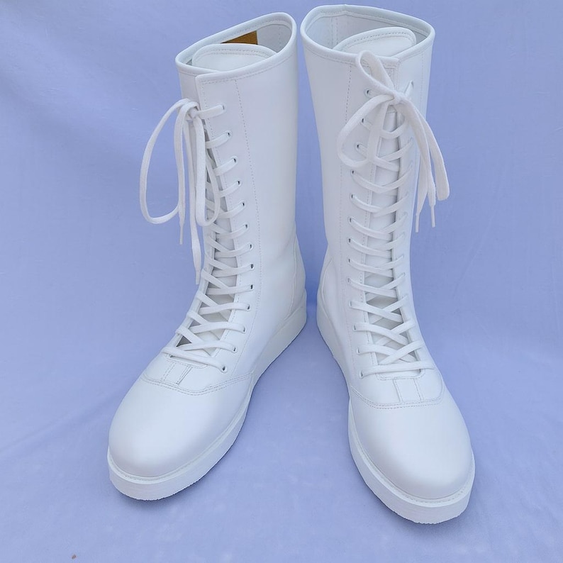 High-quality custom wrestling boots in white genuine leather with full lace-up front for secure fit and pro-level performance. Built for wrestlers who need stability, flexibility, and long-lasting comfort in the ring. Ideal for training, tournaments, martial arts practice, and stage performance.