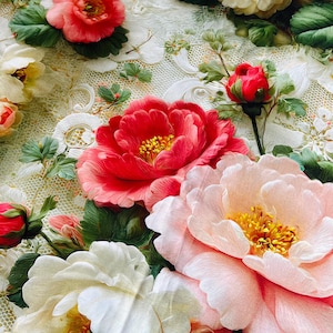 May include: A fabric featuring a detailed floral pattern with large, vibrant red, pink, and cream-coloured peony-like blossoms. The flowers are interspersed with green leaves and set against a delicate, off-white lace-like background texture.