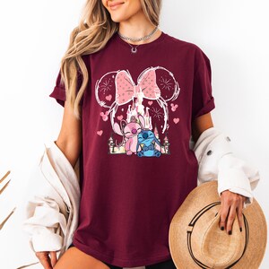 Stitch Angel castle shirt with Minnie ears and pink bow design Disney couple shirt with Stitch and Angel inspired characters pink Disney vacation tee with castle hearts and fireworks Minnie ears castle shirt with cute Stitch Angel graphic theme park outfit shirt with magical castle and pink bow Stitch and Angel Disney shirt for couple vacation outfit cute Disney lover gift shirt with castle and hearts design white Disney inspired graphic tee with Stitch Angel artwork