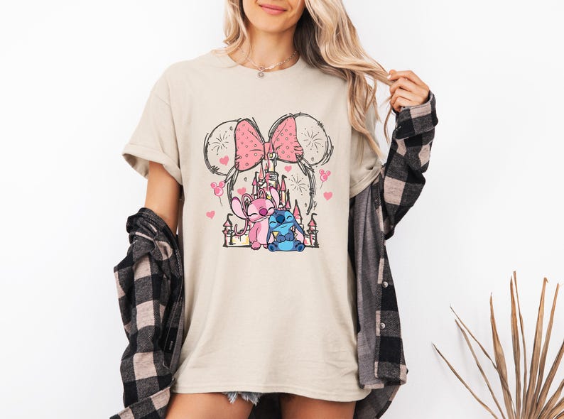 Stitch Angel castle shirt with Minnie ears and pink bow design Disney couple shirt with Stitch and Angel inspired characters pink Disney vacation tee with castle hearts and fireworks Minnie ears castle shirt with cute Stitch Angel graphic theme park outfit shirt with magical castle and pink bow Stitch and Angel Disney shirt for couple vacation outfit cute Disney lover gift shirt with castle and hearts design white Disney inspired graphic tee with Stitch Angel artwork