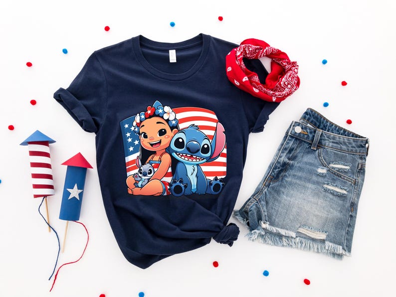 May include: Navy blue t-shirt featuring a graphic of Lilo and Stitch with an American flag background. The image is surrounded by a red bandana, denim shorts, and decorative fireworks. Red, white, and blue confetti dots the white background.