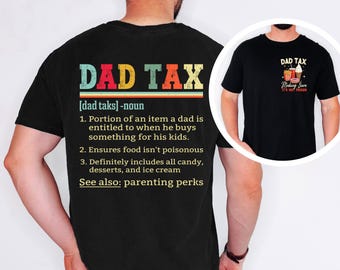 May include: Black t-shirt with the text "DAD TAX" in colorful letters. The definition of "DAD TAX" is printed below, describing the portion of an item a dad is entitled to when buying something for his kids. A smaller image shows a black t-shirt with the text "DAD TAX" and food graphics.