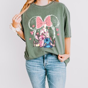 Stitch Angel castle shirt with Minnie ears and pink bow design Disney couple shirt with Stitch and Angel inspired characters pink Disney vacation tee with castle hearts and fireworks Minnie ears castle shirt with cute Stitch Angel graphic theme park outfit shirt with magical castle and pink bow Stitch and Angel Disney shirt for couple vacation outfit cute Disney lover gift shirt with castle and hearts design white Disney inspired graphic tee with Stitch Angel artwork