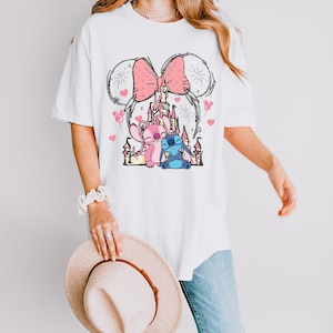Stitch Angel castle shirt with Minnie ears and pink bow design Disney couple shirt with Stitch and Angel inspired characters pink Disney vacation tee with castle hearts and fireworks Minnie ears castle shirt with cute Stitch Angel graphic theme park outfit shirt with magical castle and pink bow Stitch and Angel Disney shirt for couple vacation outfit cute Disney lover gift shirt with castle and hearts design white Disney inspired graphic tee with Stitch Angel artwork