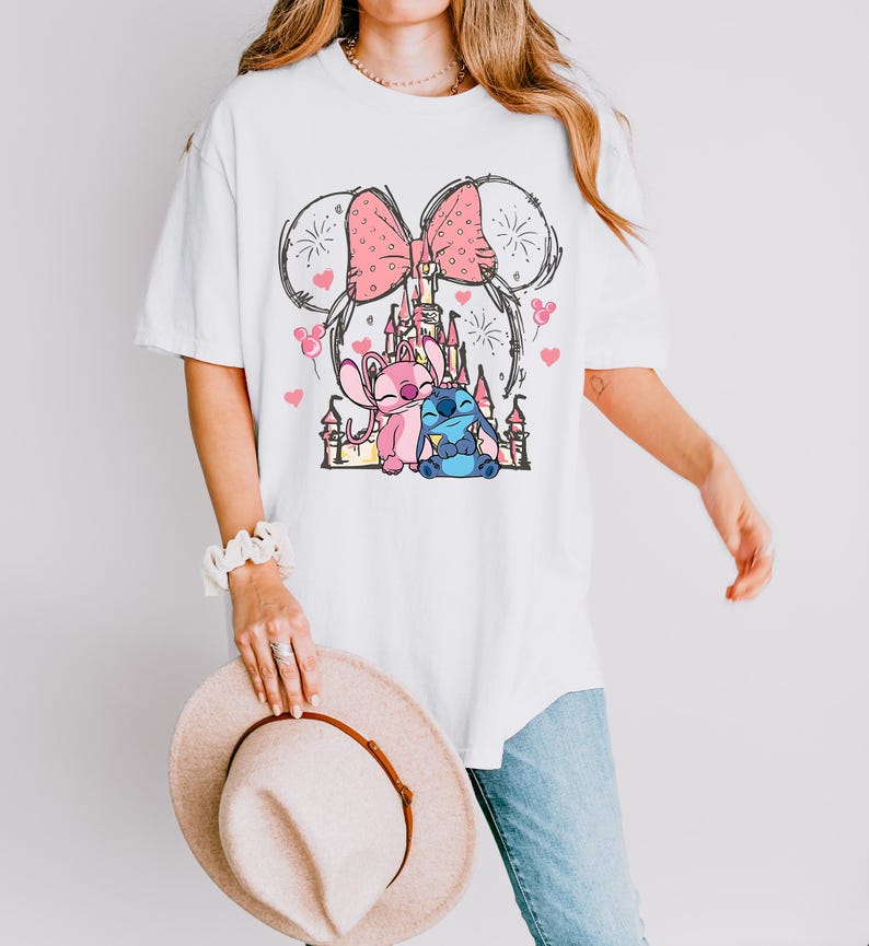 Stitch Angel castle shirt with Minnie ears and pink bow design Disney couple shirt with Stitch and Angel inspired characters pink Disney vacation tee with castle hearts and fireworks Minnie ears castle shirt with cute Stitch Angel graphic theme park outfit shirt with magical castle and pink bow Stitch and Angel Disney shirt for couple vacation outfit cute Disney lover gift shirt with castle and hearts design white Disney inspired graphic tee with Stitch Angel artwork