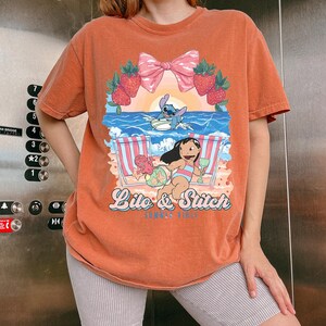 lilo and stitch summer vibes beach graphic shirt tropical vacation tee with cute beach aesthetic hawaii inspired summer sweatshirt with cartoon artwork beach vacation hoodie for tropical summer outfits cute disney inspired beach vibes t shirt coquette tropical graphic tee with strawberries and bow summer vacation outfit with tropical cartoon design beach themed summer apparel for disney lovers