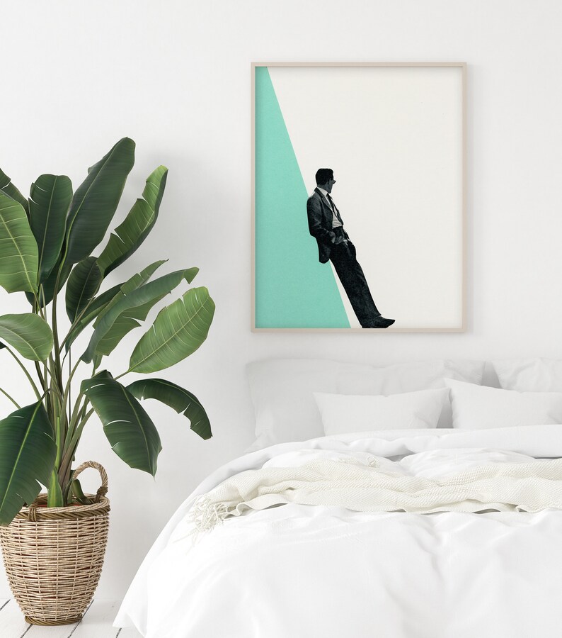 May include: A framed print of a man in a suit sitting on a diagonal line against a light blue background.