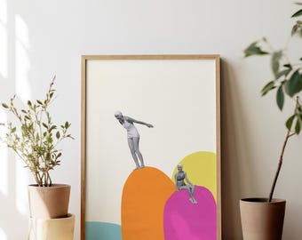 May include: A framed art print featuring a collage of two black and white figures in vintage swimwear. One figure stands on a large orange shape, while the other sits on a magenta shape. The background includes a light blue shape and a yellow circle.