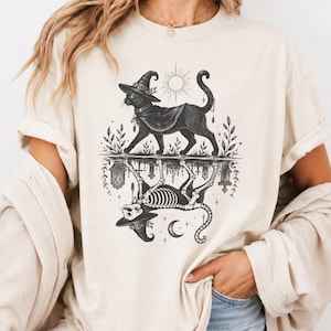 Vintage Witch Cat Skeleton Art | Mirrored Celestial Familiar Graphic | Dark Botanical Halloween Style | Comfort Colors 1717 Unisex Tee