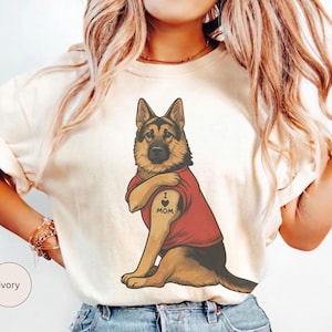 German Shepherd dog illustration wearing a red shirt, lifting sleeve to reveal “I love mom” tattoo, vintage style retro pet graphic, bold clean lines, centered composition, perfect for dog lovers and animal themed apparel designs