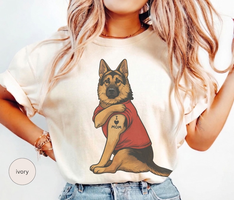 German Shepherd dog illustration wearing a red shirt, lifting sleeve to reveal “I love mom” tattoo, vintage style retro pet graphic, bold clean lines, centered composition, perfect for dog lovers and animal themed apparel designs