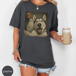 Startled Husky taking a Halloween selfie with a sheet ghost holding an orange BOO balloon in a distressed vintage photo design.
