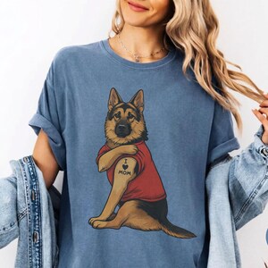 German Shepherd dog illustration wearing a red shirt, lifting sleeve to reveal “I love mom” tattoo, vintage style retro pet graphic, bold clean lines, centered composition, perfect for dog lovers and animal themed apparel designs